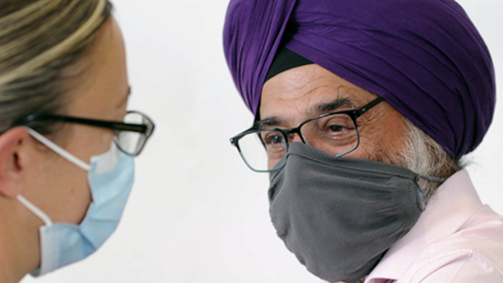 Doctor and patient wearing face coverings